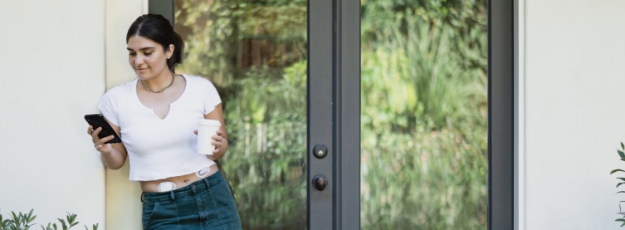 G6 Omnipod outdoor girl looking at phone on porch