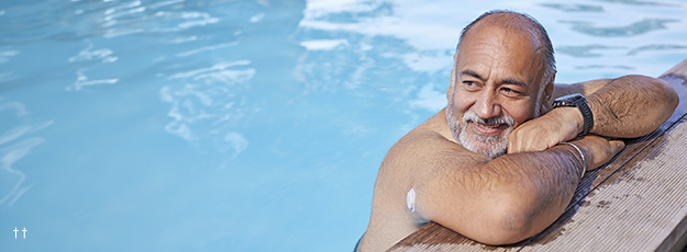 Man in pool wearing Dexcom ONE+